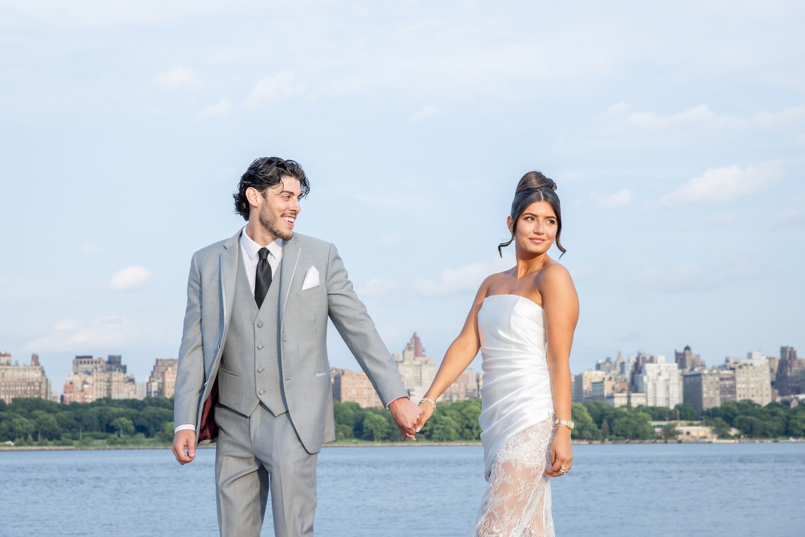 Couple holding hands beside the water