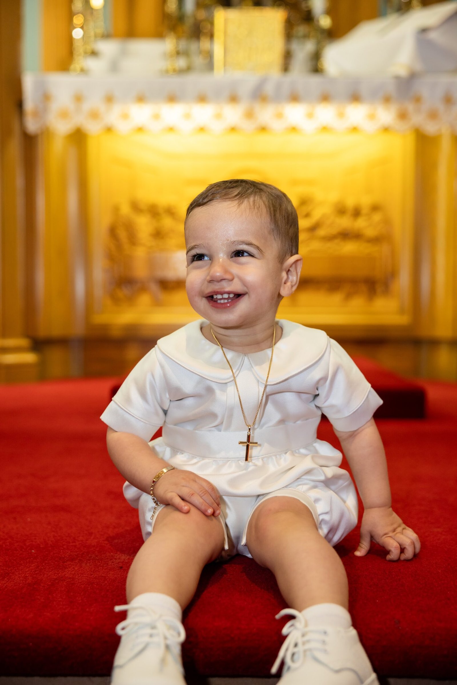 Young boy in white on his christening day
