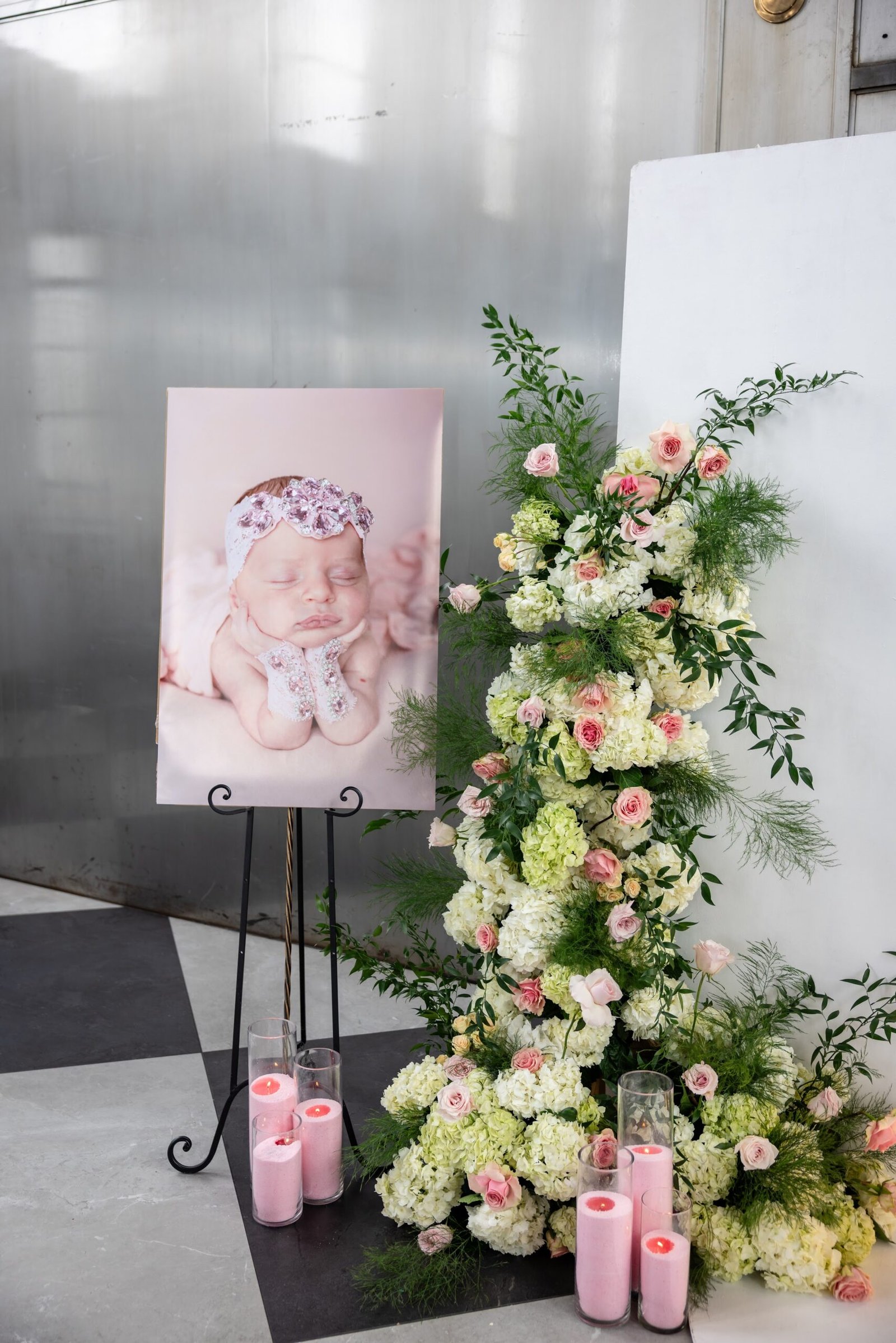 Welcome portrait on an easel beside a floral arrangement