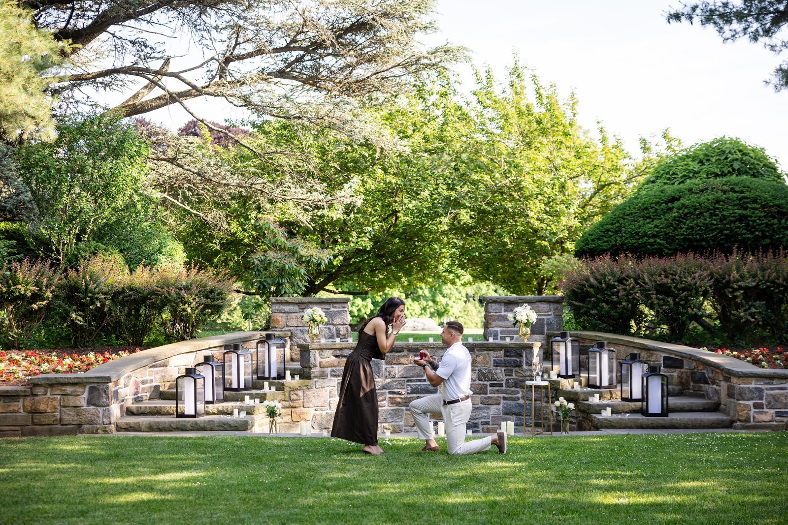 Proposal on one knee in a candlelit garden