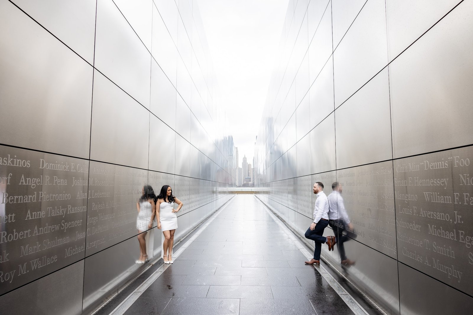 Black and white photograph of the couple framed by the long corridor of the Empty Sky Memorial