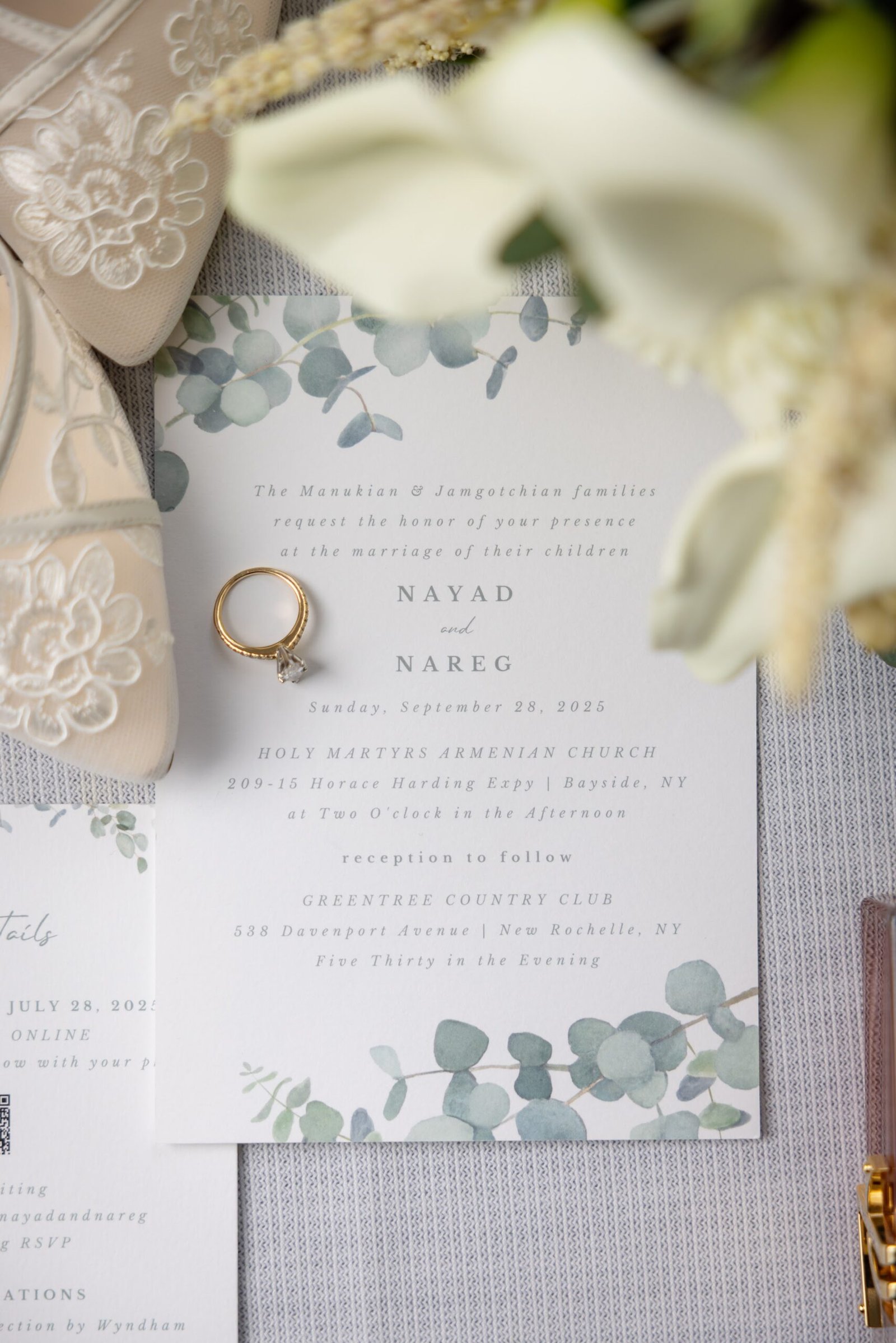 Wedding invitation and rings styled with eucalyptus